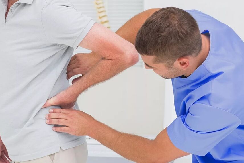 A patient with a waist pain in a diagnostic examination by a doctor